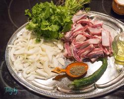 Delicious pork ribs with potatoes in a cauldron over a fire Recipe for khash in a cauldron pork ribs